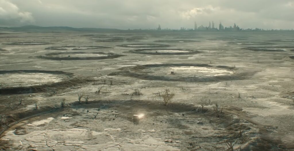 widescreen view of desolate barren flat landscape against gray-green sky