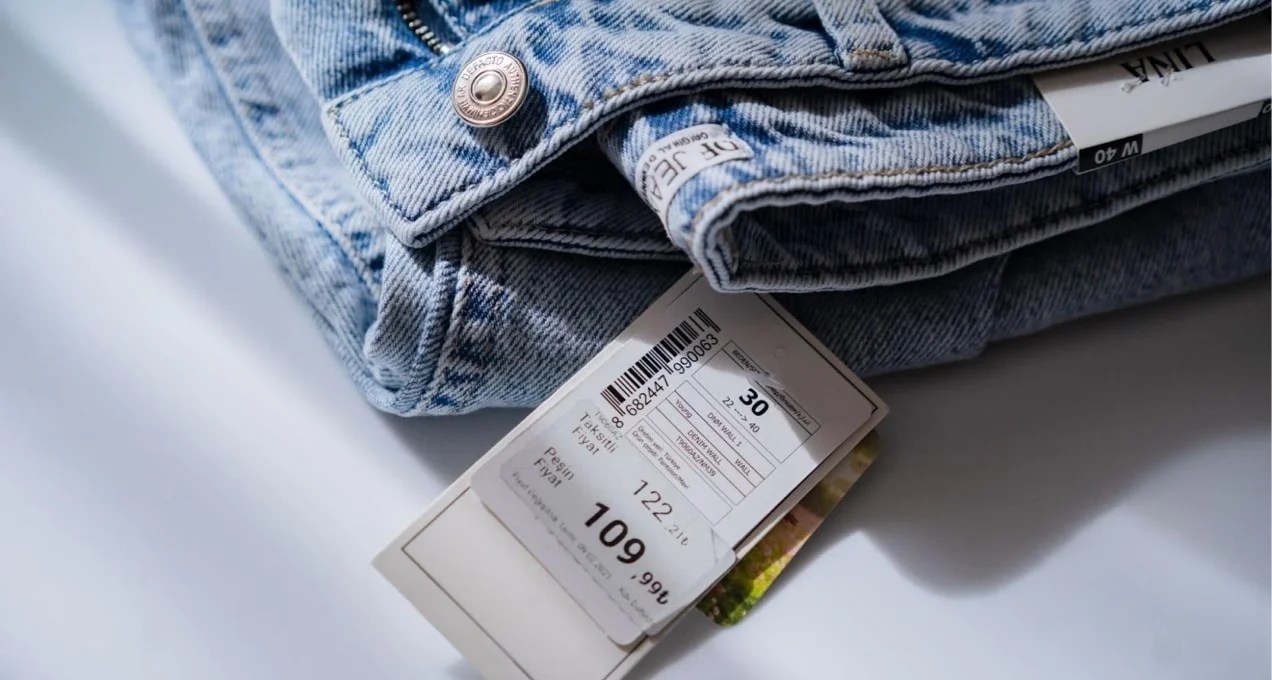 folded pair of jeans with a size and price tag
