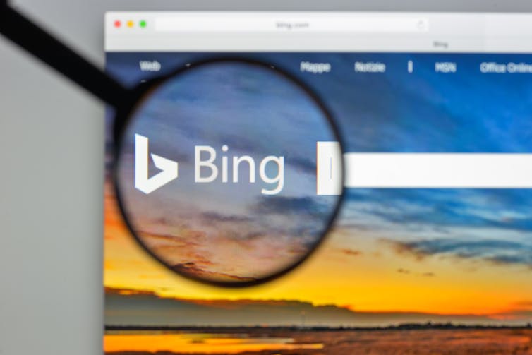 A magnifying glass held over an internet search bar.