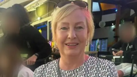 Facebook A woman with blond hair and sunglasses on her head smiles for the camera