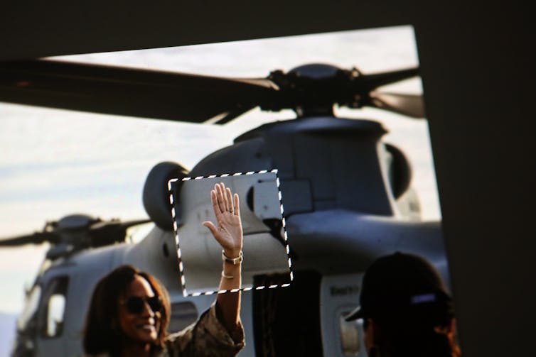 An AI-generated image shows a woman waving with a six-fingered hand.