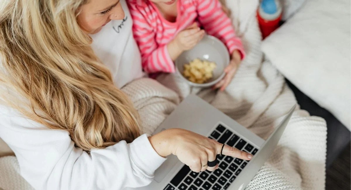 mother and child watching a movie on a laptop