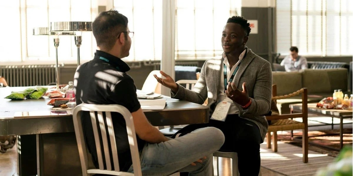 two men chatting in a coffee shop