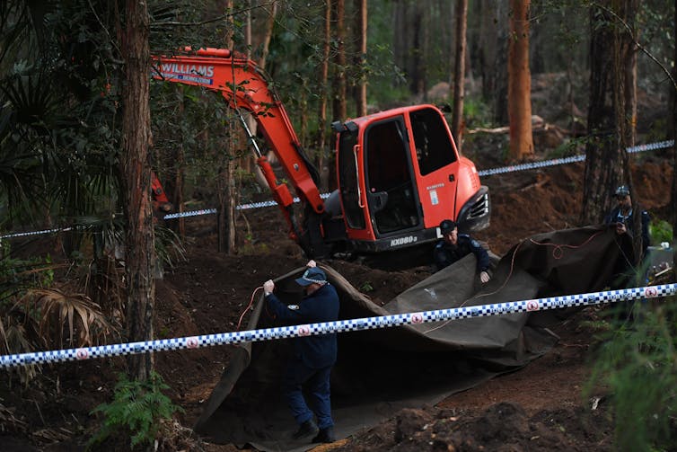 Police hunt through bushland for a victim's remains.
