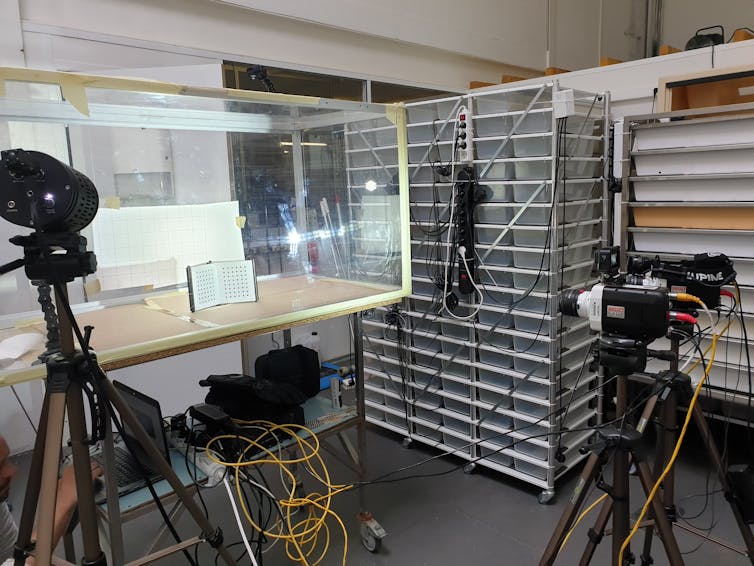 Cameras and lights surrounding a plexi glass box.