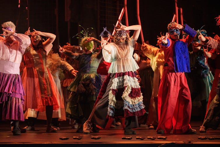 The ball-goers dance.