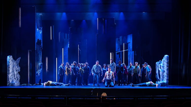 Wide shot of the stage. Romeo kneels between two dead bodies.