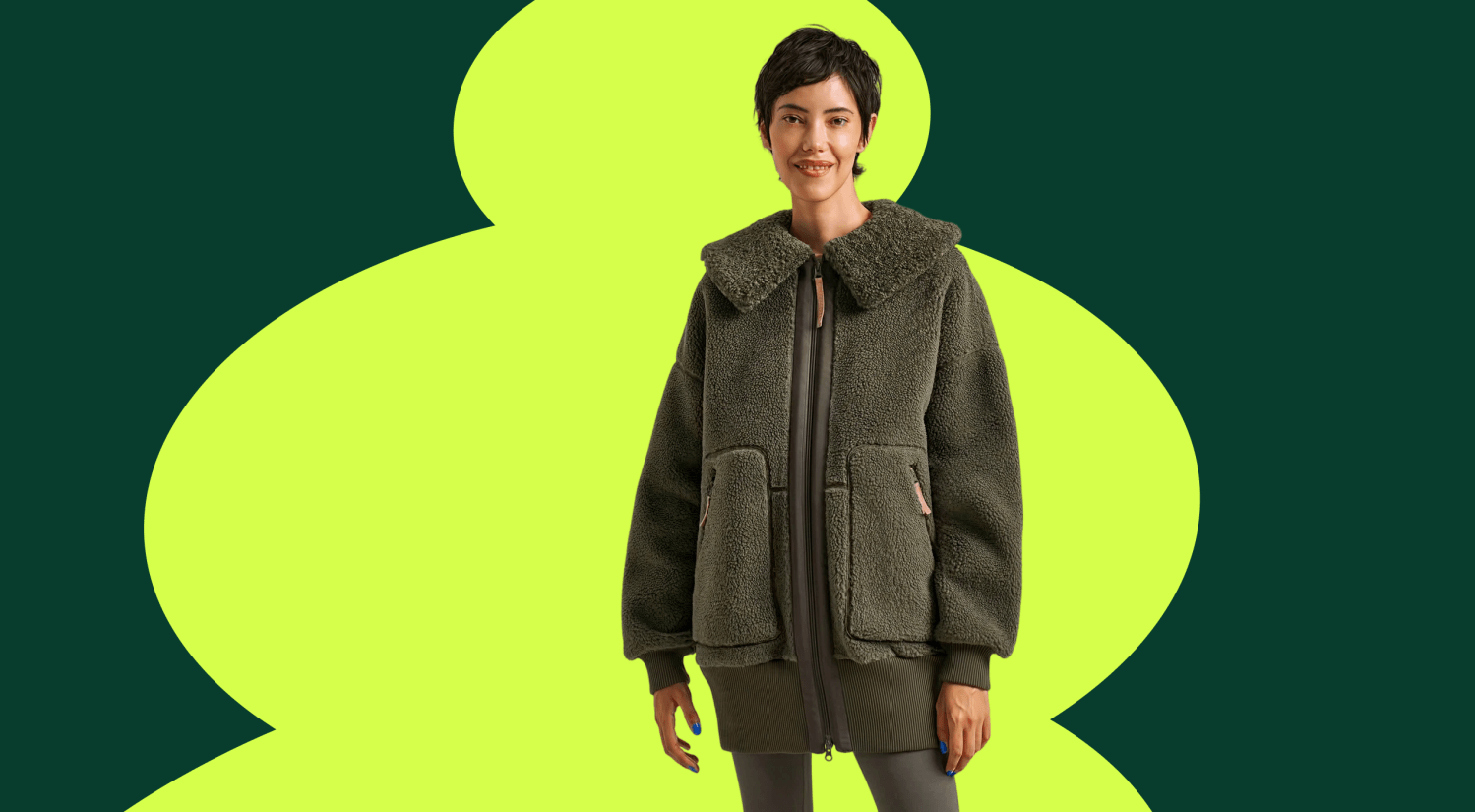 a woman standing in front of a green background wearing a green fleece jacket from Bamboo Clothing