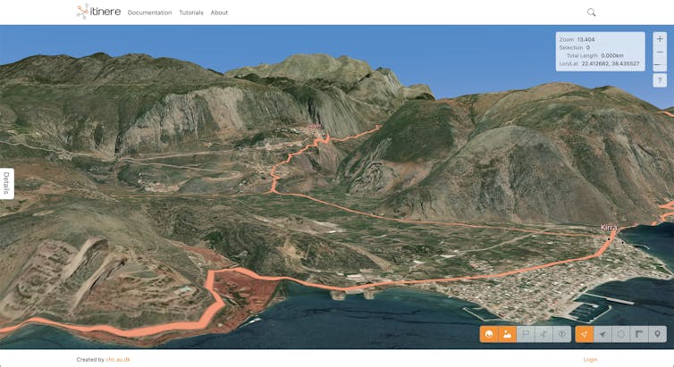 A topographical view of a town and hills showing a road winding through them.