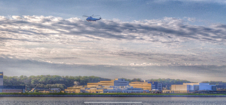 A plane flying over a building.