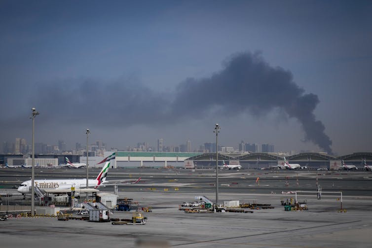 Smoke seen rising near Dubai International Airport following an Iranian strike.