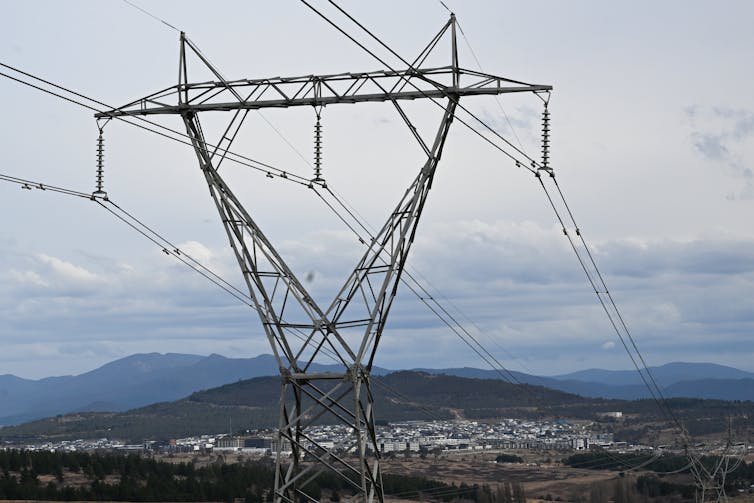 power lines, town behind them.