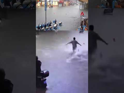 Woman in China saved by neighbours after falling in floodwater