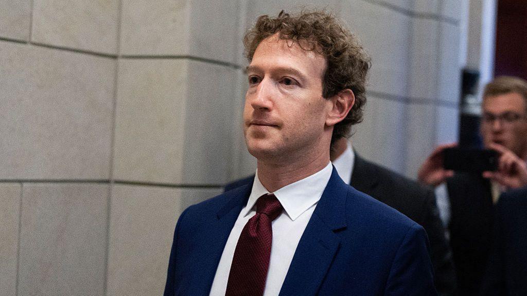Mark Zuckerberg, chief executive of Meta, wearing a dark blue suit with a dark red tie