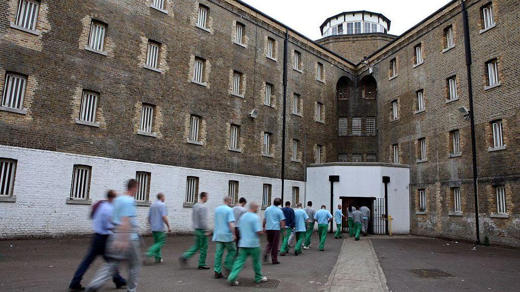 Unidentified prisoners return from their jobs to their wings for lunch at Wandsworth prison