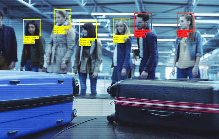 Queue in airport being scanned.